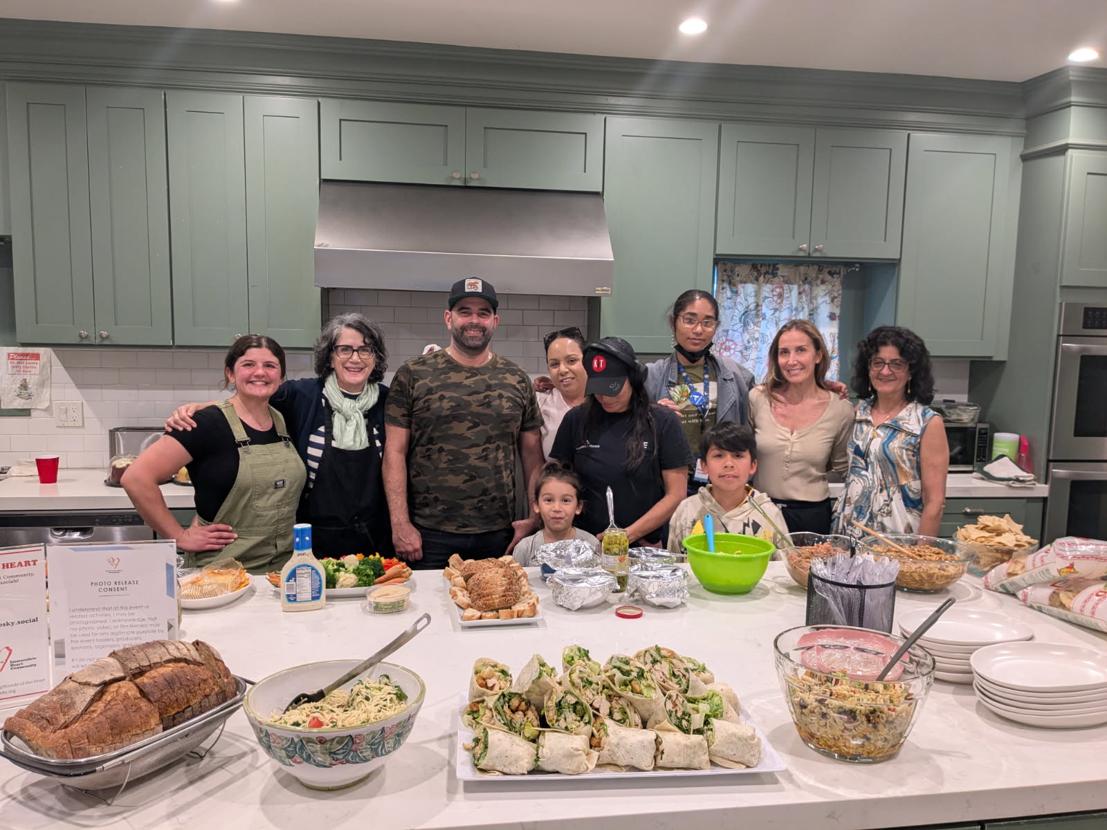 Be Kind Connection dinner crew gathered in the kitchen around the night's spread